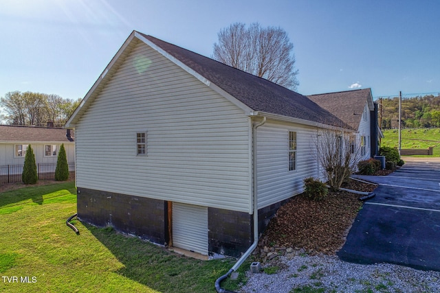 view of side of property featuring a yard