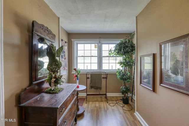 entrance foyer with a textured ceiling and hardwood / wood-style floors