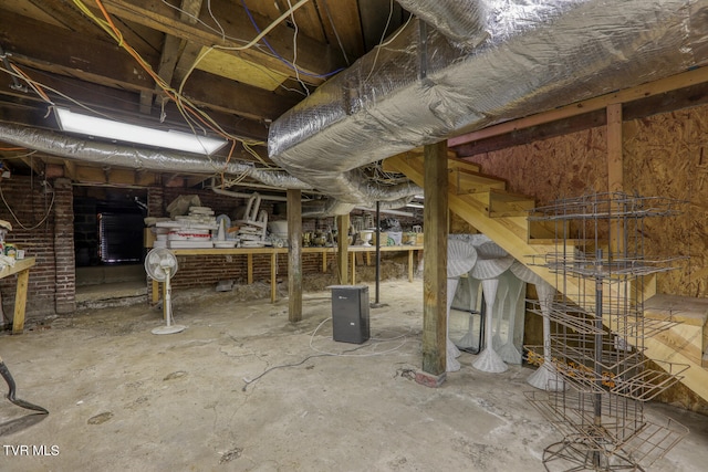 basement featuring brick wall