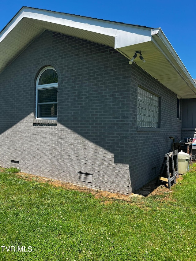 view of property exterior with a lawn