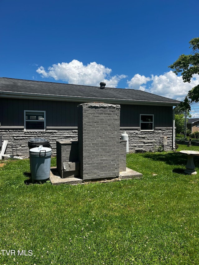 view of side of home featuring a yard