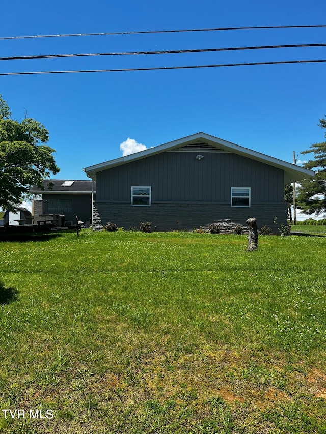 view of side of property with a yard