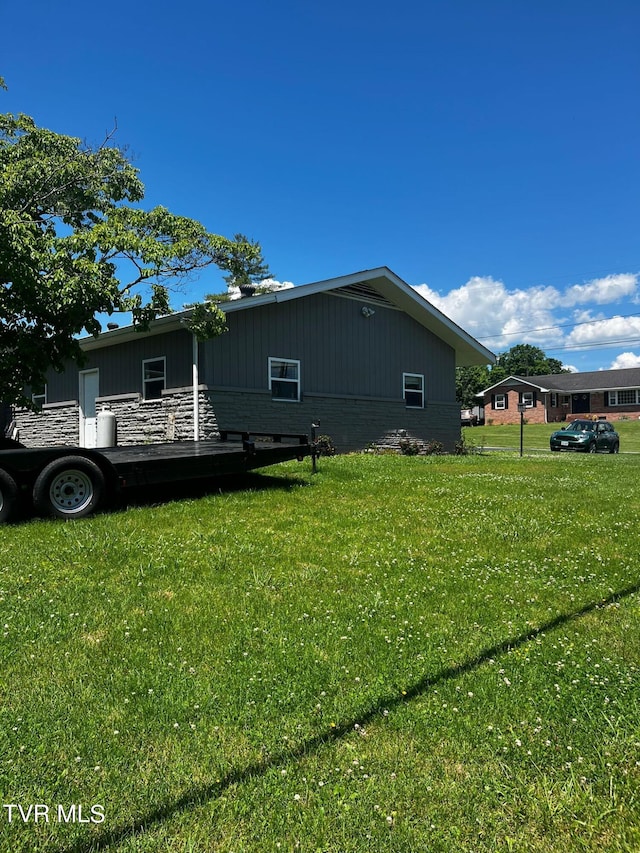 view of property exterior with a lawn