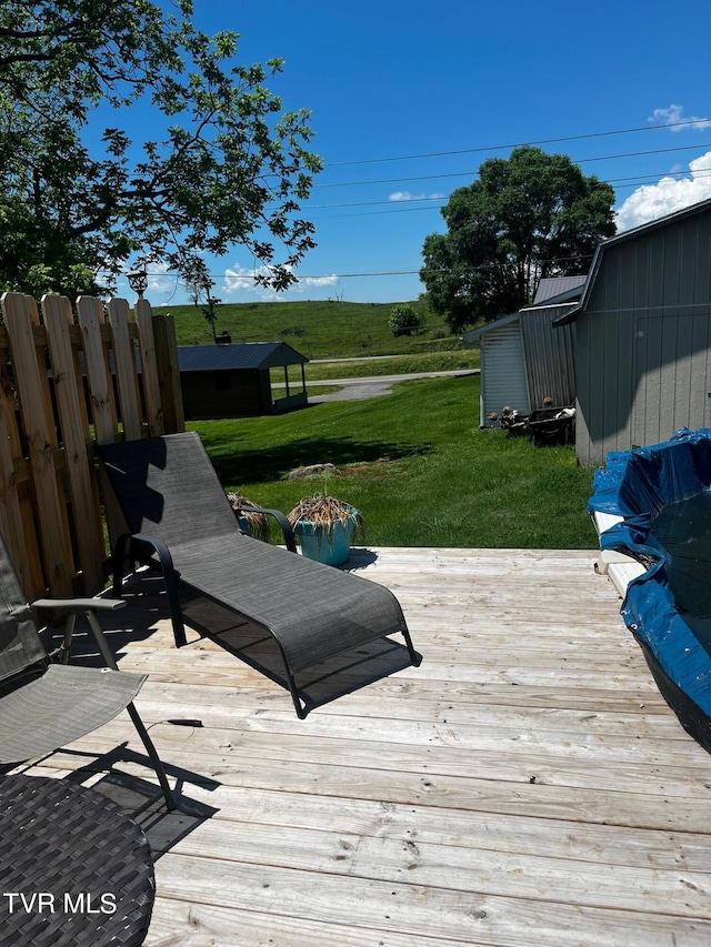 wooden terrace featuring a yard