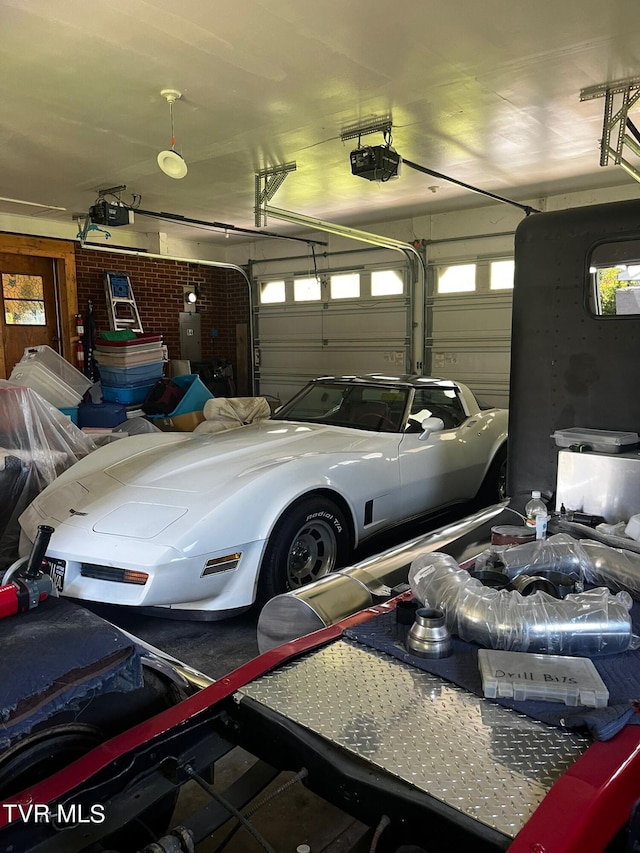 garage featuring a garage door opener and electric panel