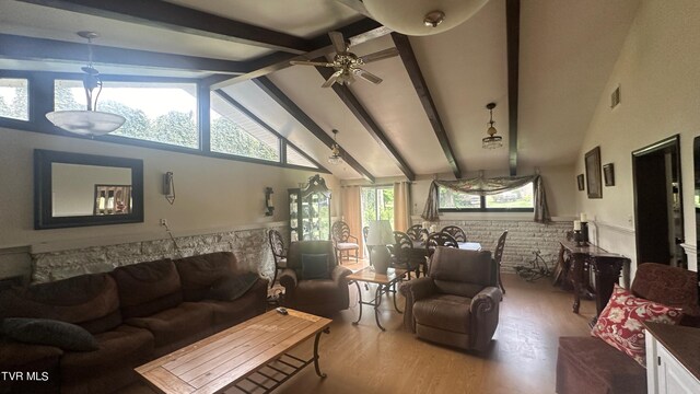 living room featuring beamed ceiling, wood-type flooring, ceiling fan, and high vaulted ceiling