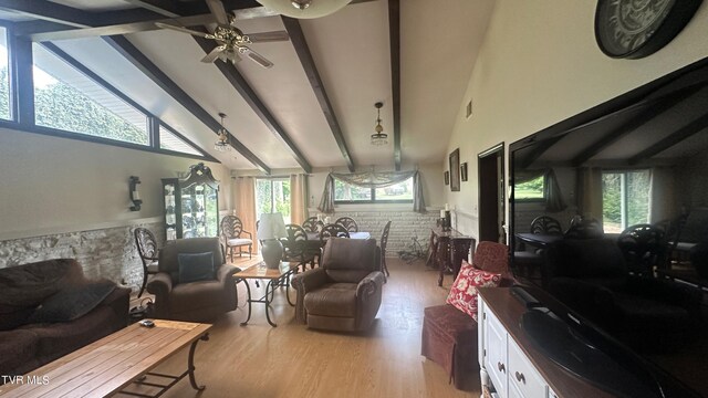 living room featuring ceiling fan, high vaulted ceiling, light hardwood / wood-style floors, and beamed ceiling