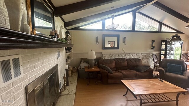 living room with hardwood / wood-style flooring and lofted ceiling with beams