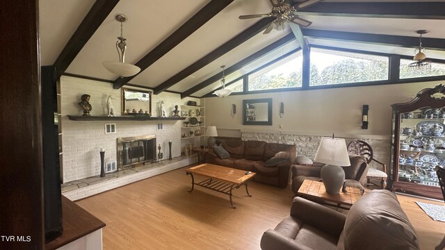 living room with high vaulted ceiling, a fireplace, beamed ceiling, hardwood / wood-style flooring, and ceiling fan