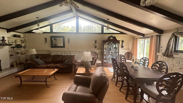 living room featuring ceiling fan, lofted ceiling with beams, and light hardwood / wood-style flooring