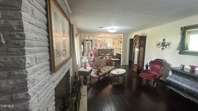 living area with dark wood-type flooring and a textured ceiling