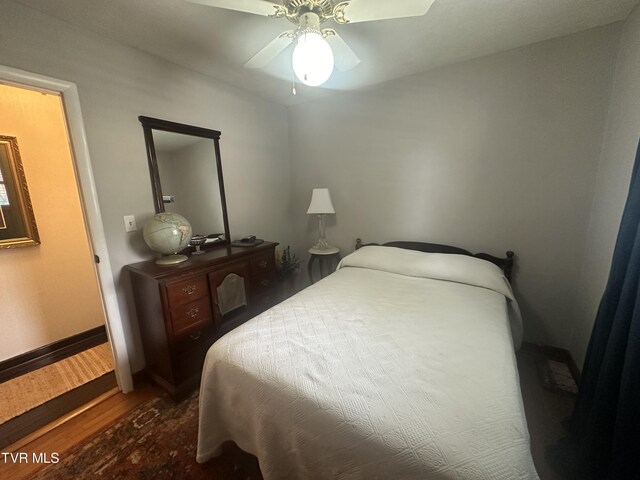 bedroom featuring ceiling fan and dark hardwood / wood-style flooring