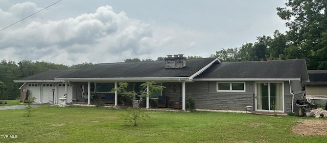 view of front of home with a garage and a front lawn