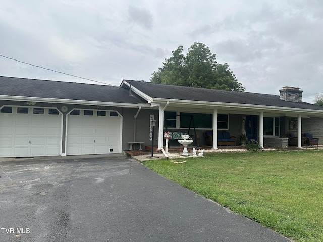 ranch-style home featuring a garage and a front lawn