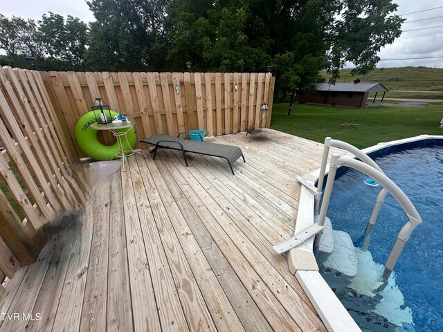 wooden terrace featuring a yard