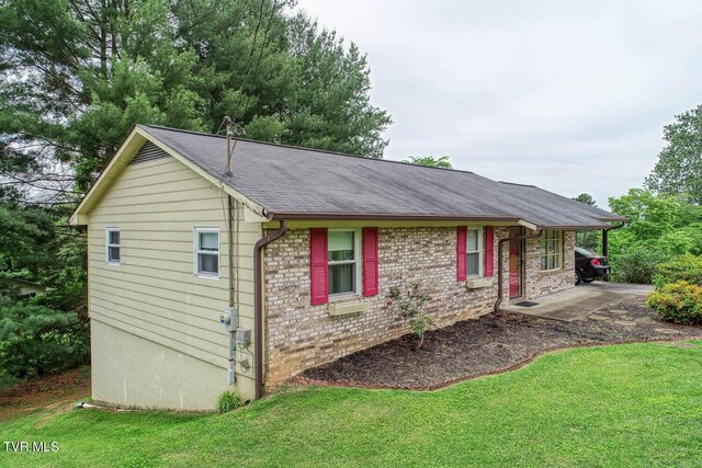 single story home with a front yard and a patio