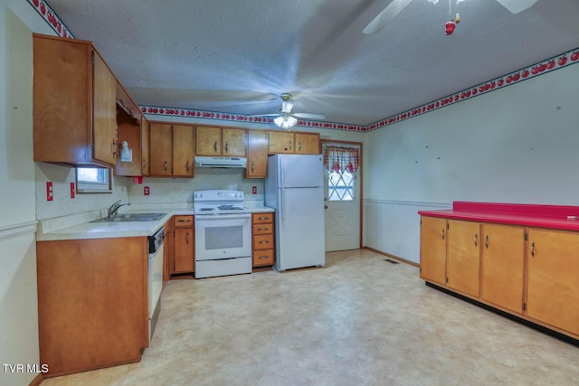 kitchen featuring ceiling fan, sink, and white appliances