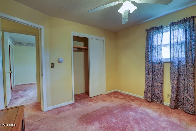 unfurnished bedroom with ceiling fan, a closet, and light colored carpet