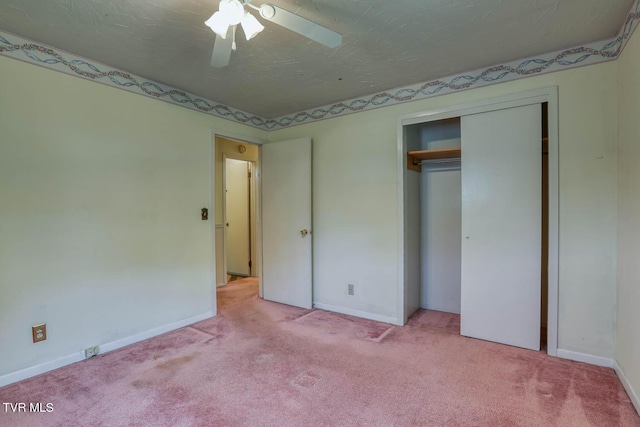 unfurnished bedroom featuring ceiling fan, a closet, and light carpet