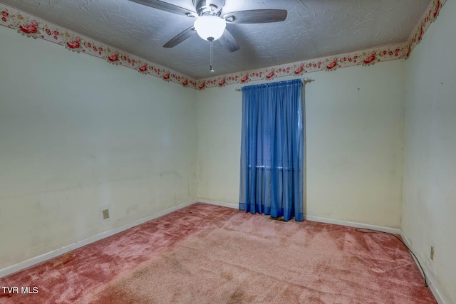 spare room featuring ceiling fan, carpet, and a textured ceiling