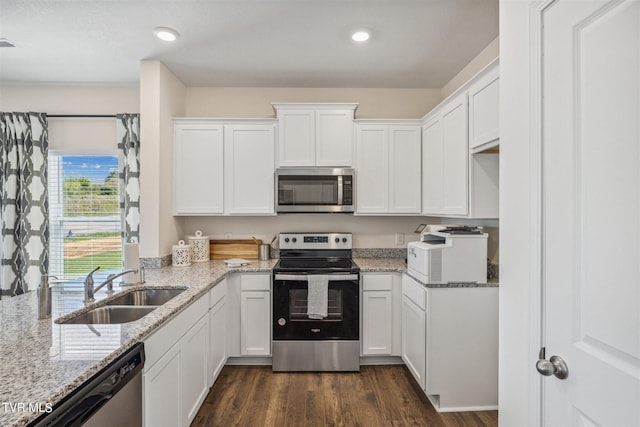 115 Raceday Center Dr Unit E-3, Bristol, TN 37620 - kitchen with white cabinets, light stone counters, a sink, stainless steel appliances, and dark wood-type flooring