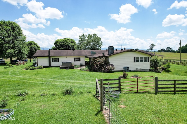 exterior space with a front lawn and a rural view