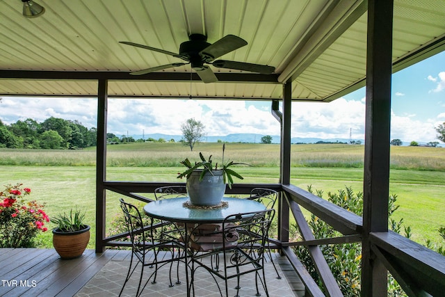 exterior space featuring ceiling fan and a rural view