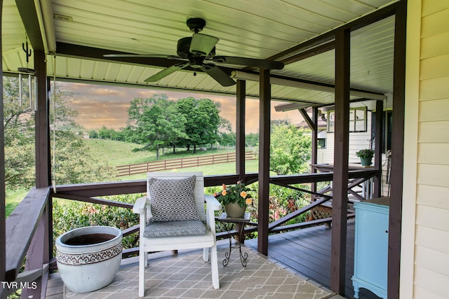 sunroom featuring ceiling fan