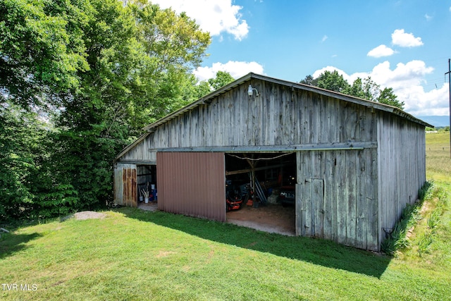 view of outdoor structure featuring a lawn