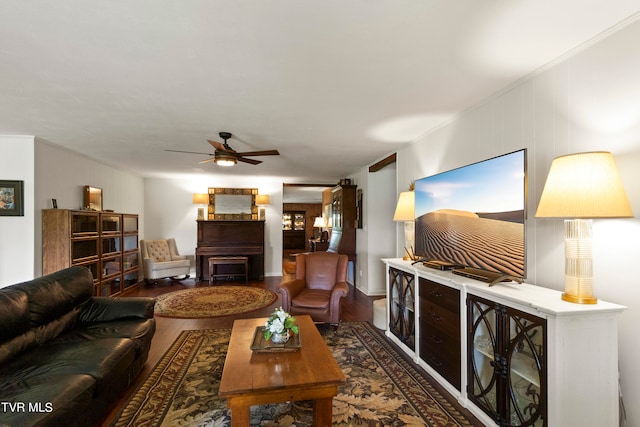 living room featuring ceiling fan, hardwood / wood-style floors, and ornamental molding