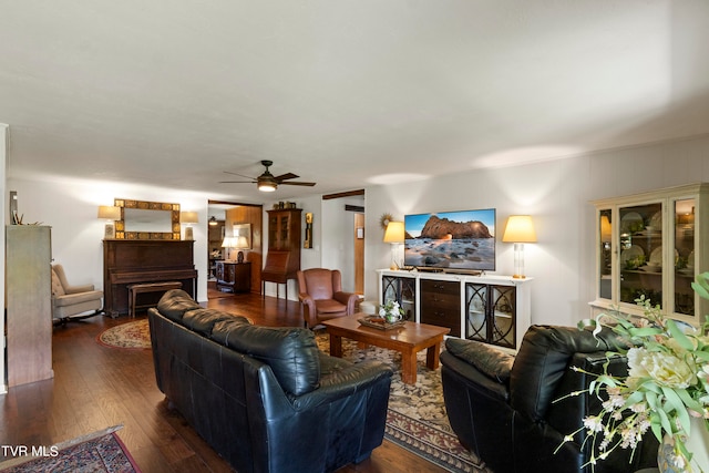 living room with wood-type flooring and ceiling fan