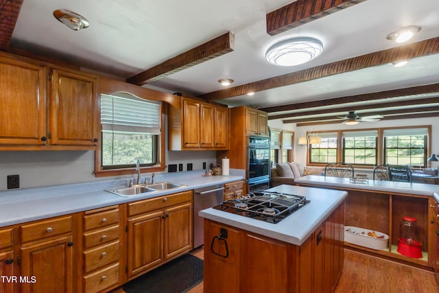 kitchen featuring beamed ceiling, sink, plenty of natural light, and appliances with stainless steel finishes