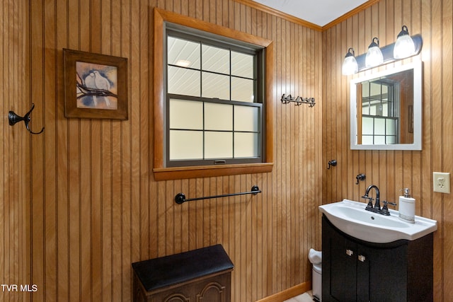 bathroom featuring wooden walls, vanity, and toilet