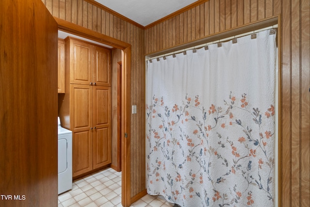 bathroom with crown molding, tile flooring, and washer / clothes dryer