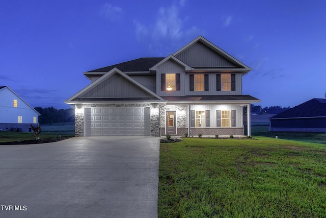 view of front of property featuring a garage and a yard