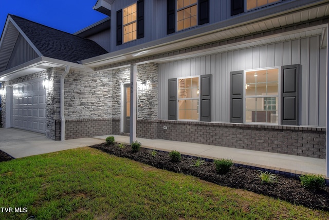 view of home's exterior with a garage and a lawn