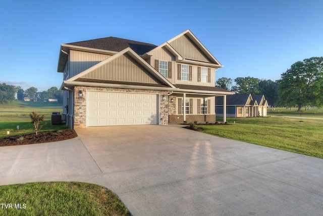 craftsman-style house featuring central AC, a front lawn, and a garage