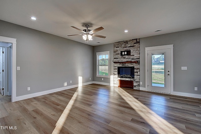 unfurnished living room with light hardwood / wood-style floors, plenty of natural light, and ceiling fan