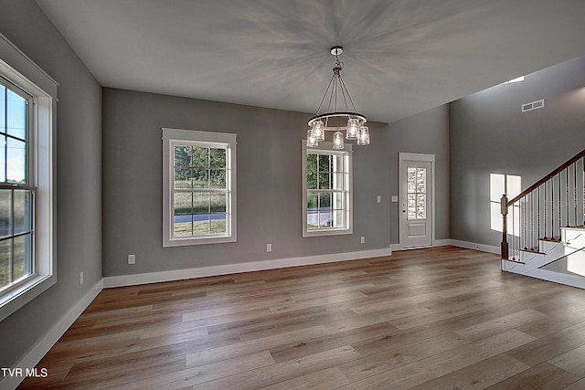 interior space featuring light hardwood / wood-style flooring and a notable chandelier