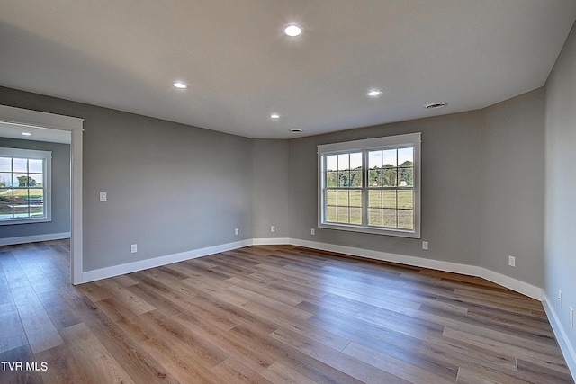 spare room featuring light hardwood / wood-style floors