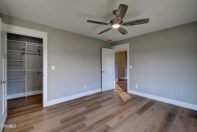 unfurnished bedroom with ceiling fan, a closet, and light hardwood / wood-style flooring