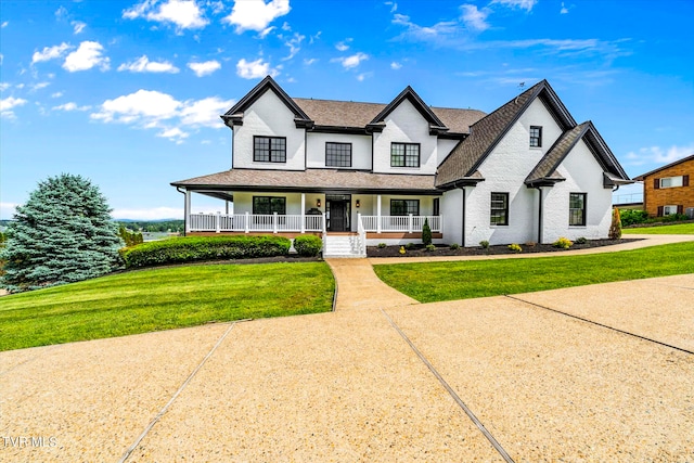 view of front of property featuring central AC unit, a front lawn, and covered porch