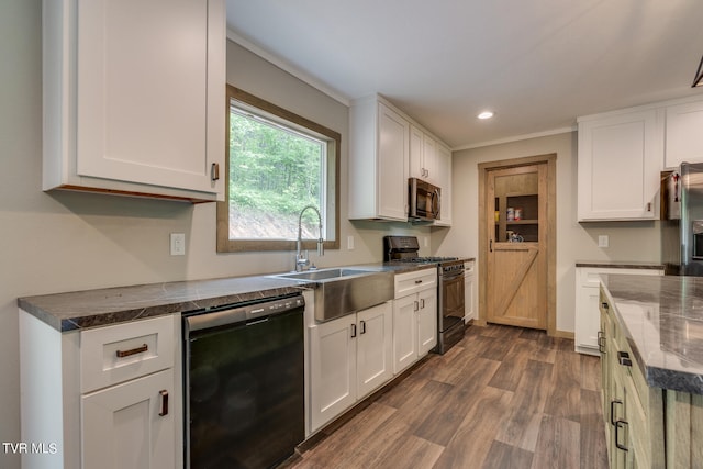 kitchen with white cabinetry, black appliances, ornamental molding, dark wood-type flooring, and sink