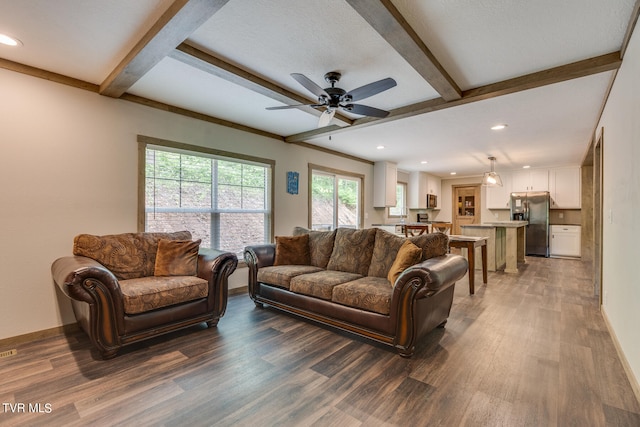 living room with beam ceiling, ceiling fan, and hardwood / wood-style floors