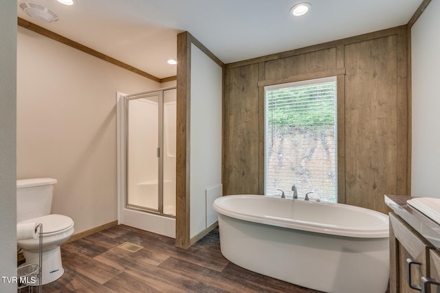 full bathroom with crown molding, hardwood / wood-style floors, independent shower and bath, toilet, and vanity