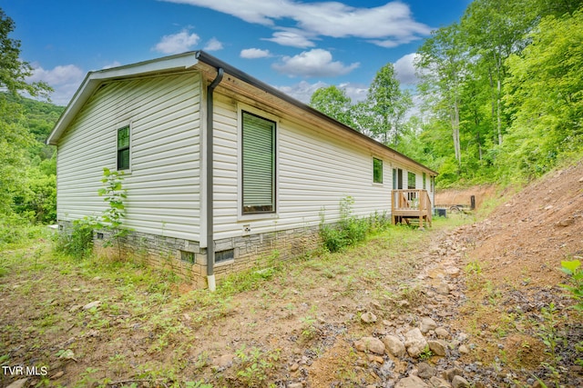 view of side of property featuring a deck