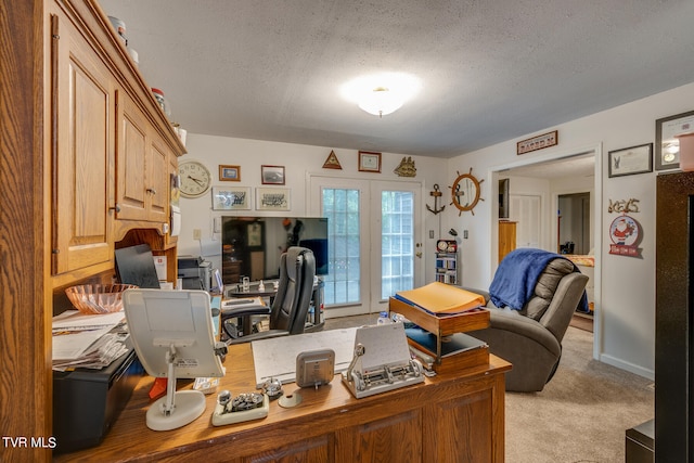 office space featuring french doors, a textured ceiling, and light carpet