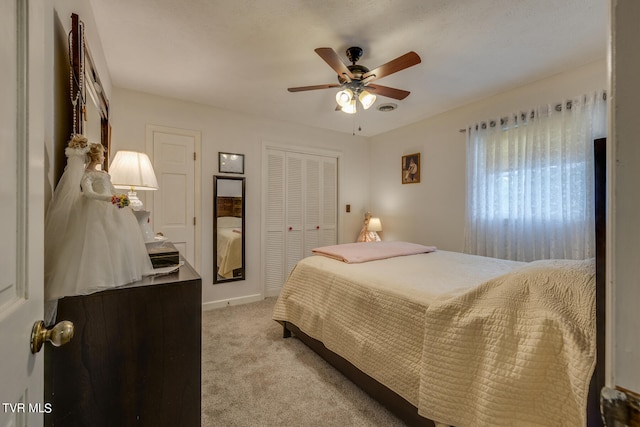 bedroom with ceiling fan, a closet, and carpet floors