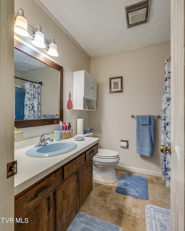 bathroom featuring tile flooring, vanity, toilet, and a textured ceiling