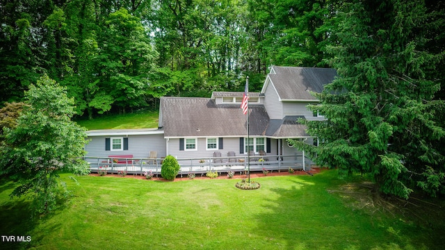 exterior space with a deck and a lawn